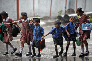 Indian school children walk in the rain in Hyderabad, India, Friday, July 20, 2012. The monsoon rains which usually hit India from June to September are crucial for farmers whose crops feed hundreds of millions of people. (AP Photo/Mahesh Kumar A)